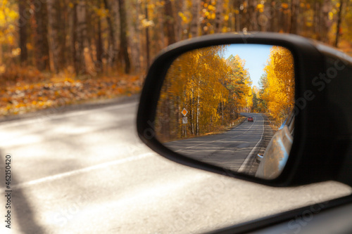  The car's rearview mirror reflects a sharp turn.