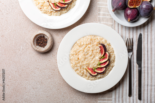 Risotto made with taleggio cheese, rosemary and fresh figs. Italian dinner. Vegetarian rice dish. Horizontal image.