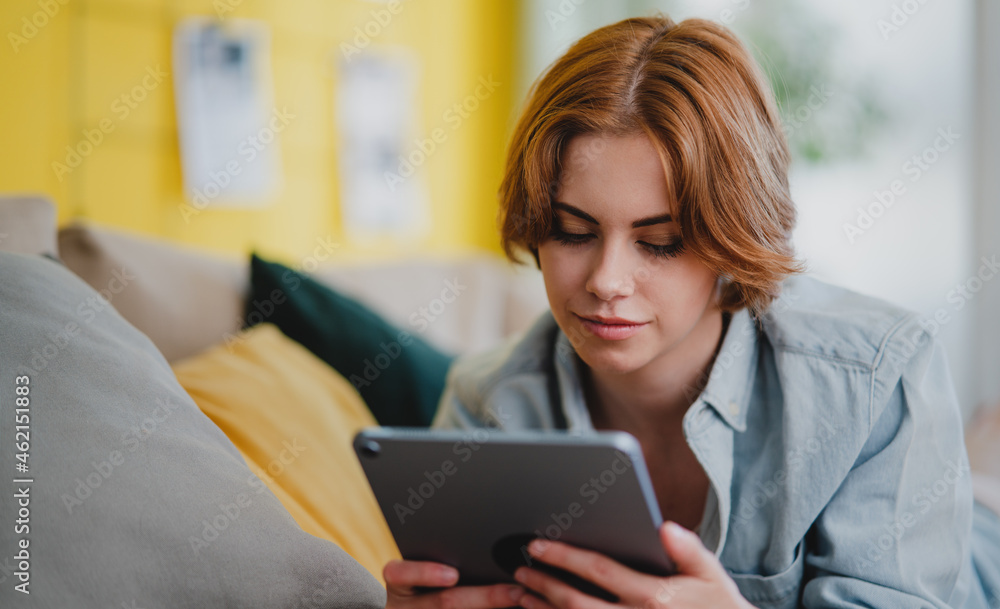 Portrait of young woman using smartphone, lying on sofa at home, social networks concept. Portrait of young woman using smartphone, lying on sofa at home, social networks concept.