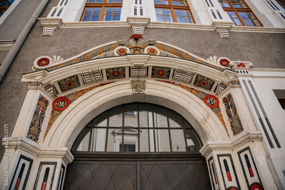 Goerlitz, Saxony, Germany, 04 September 2021: antique renaissance portal, floral ornaments, entrance to house at sunny summer day, historic building facade with stucco and statues, wood carved doors