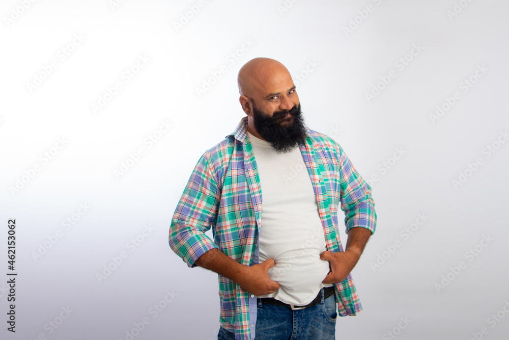Indian Strong Healthy confident bald guy overweight obese man's hand holding his big belly Indian Strong Healthy confident bald guy overweight obese man's hand holding his big belly