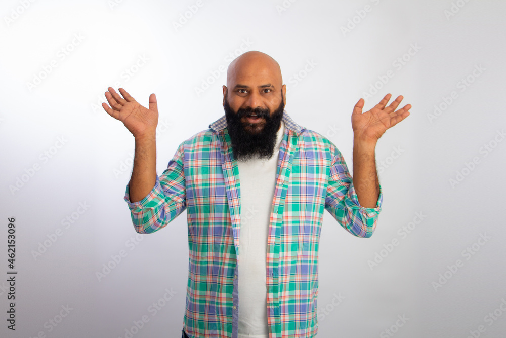 Surprised Indian healthy bald beard man. People lifestyle concept. Keeping mouth open spreading hands Surprised Indian healthy bald beard man. People lifestyle concept. Keeping mouth open spreading hands