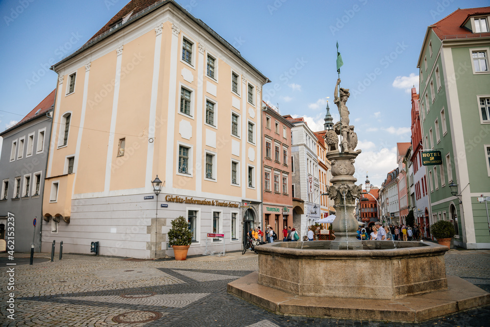 Goerlitz, Saxony, Germany, 04 September 2021:  Georgsbrunnen or George's fountain at Obermarkt or Upper market, picturesque street with renaissance baroque historical buildings at summer sunny day