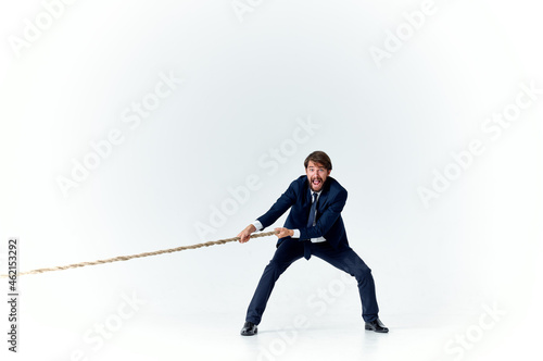business man in suit pulling rope career office manager