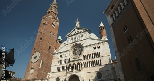 Cremona Cathedral. Cremona Cathedral and torrazzo.Facade of the cathedral covered in white Carrara marble. Statues and decorative arches.  Cremona, Lombardy.