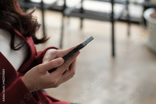 Close up women's hands use a smartphone for online shopping, social networking, or remote work