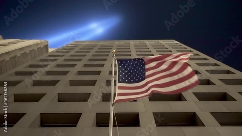 American Flag Waving On Building In NYC Under September 11th Memorial Lights photo