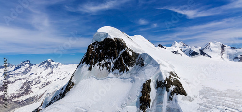 Banner of winter season with Swiss Mountain  of snow ice against the blue sky bckground photo