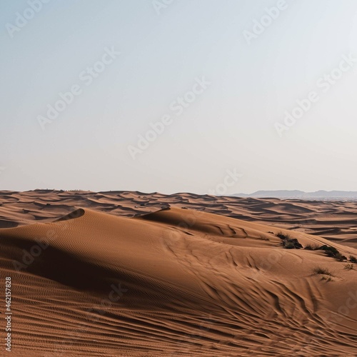 Brown sand under white sky.