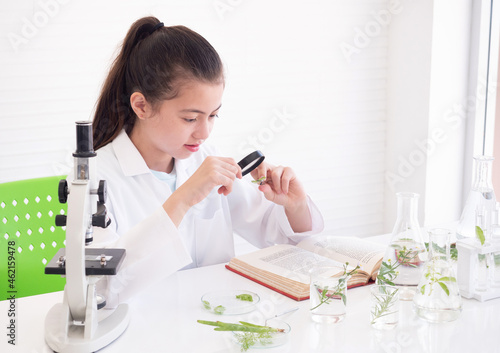 Child girl learning science chemistry plant in laboratory. Educational concept. Early development of children.