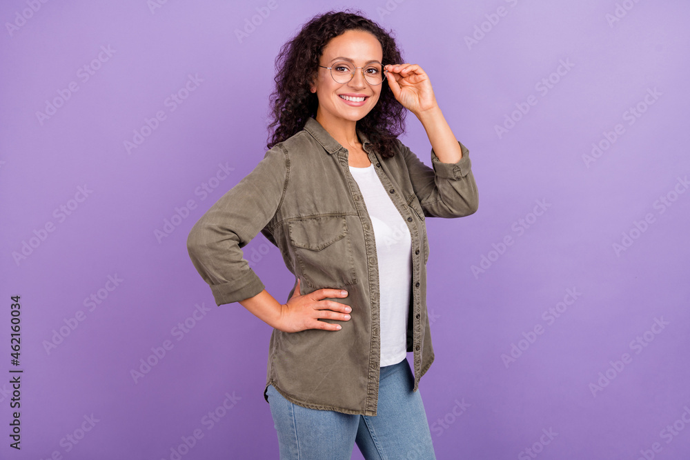 Photo of cheerful happy young afro american woman wear spectacles hand waist smile isolated on violet color background Photo of cheerful happy young afro american woman wear spectacles hand waist smile isolated on violet color background
