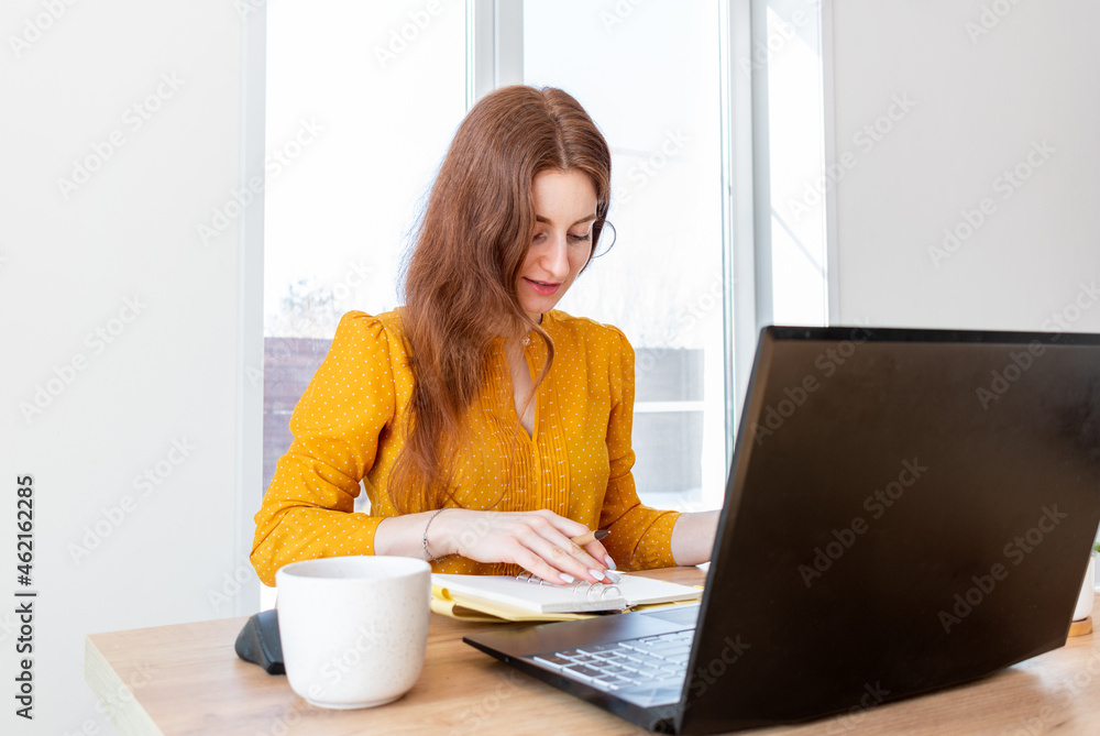 Defocus. Young woman is education online by using computer. Female freelancer browsing laptop. Defocus. Young woman is education online by using computer. Female freelancer browsing laptop.