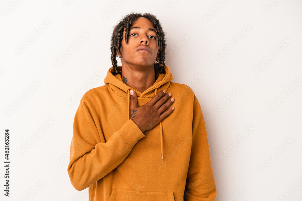 Young african american man isolated on white background taking an oath, putting hand on chest. Young african american man isolated on white background taking an oath, putting hand on chest.