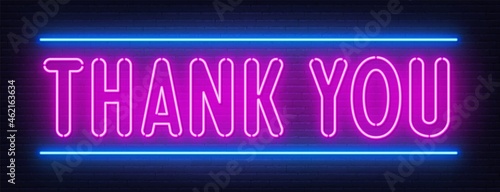 Thank you neon sign on brick wall background.