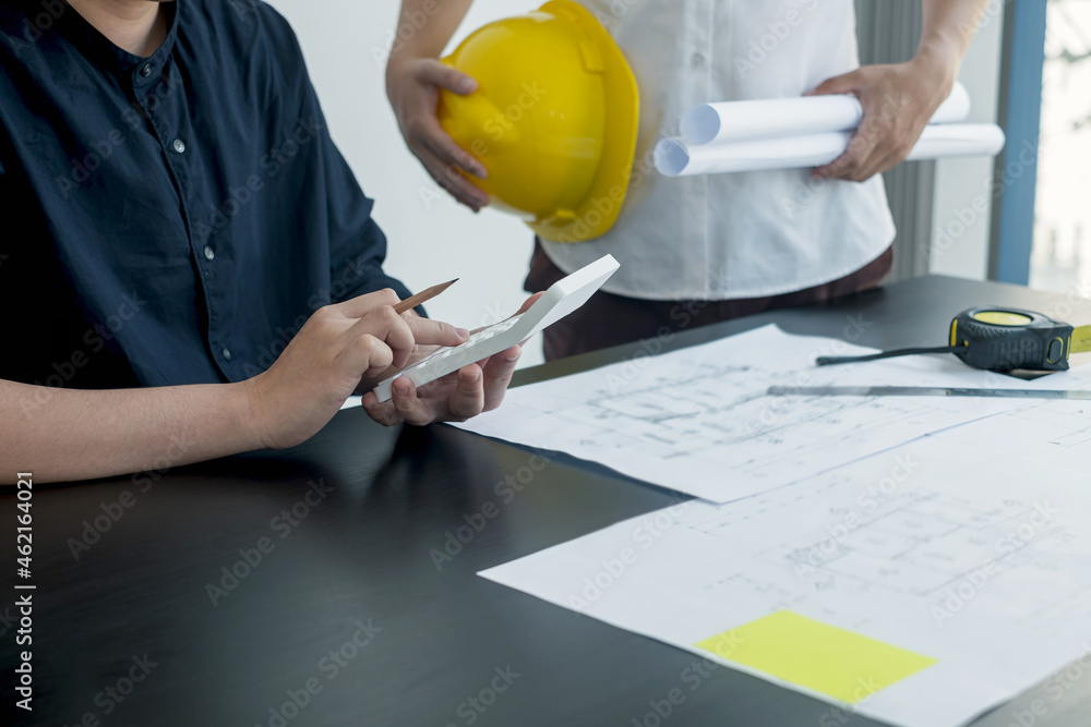 Team of engineers and architects, working team, meeting, discussing construction and drawing construction plans, printing, writing on-site construction sites. Home design concept Team of engineers and architects, working team, meeting, discussing construction and drawing construction plans, printing, writing on-site construction sites. Home design concept