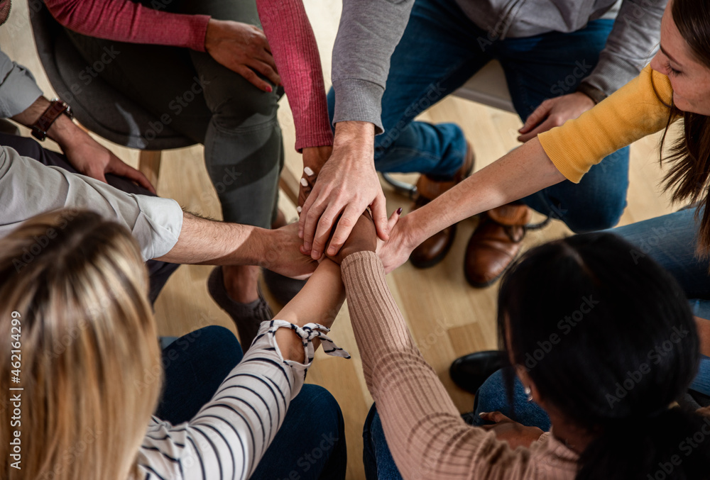 Fototapeta premium Diverse group of people sitting in circle in group therapy session.
