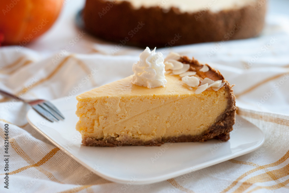 A piece of pumpkin pie with whipped cream A piece of pumpkin pie with whipped cream