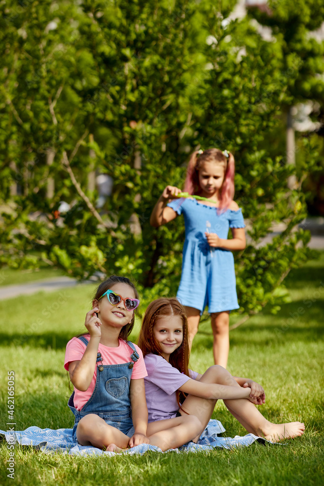 kids playing with soap bubbles in the park kids playing with soap bubbles in the park