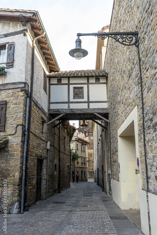 Narrow street, Facade of a medieval building in the center of Pamplona, medieval stone streets, typical and tourist alley of the city. Navarra Spain Narrow street, Facade of a medieval building in the center of Pamplona, medieval stone streets, typical and tourist alley of the city. Navarra Spain