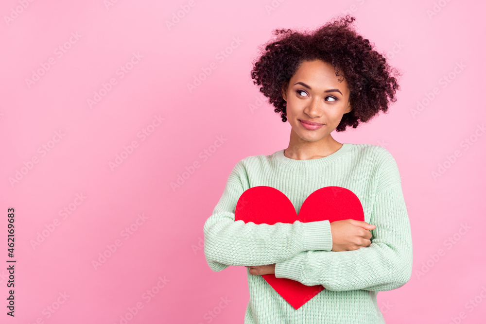 Portrait of adorable peaceful dark skin person hold red paper card look empty space isolated on pink color background Portrait of adorable peaceful dark skin person hold red paper card look empty space isolated on pink color background