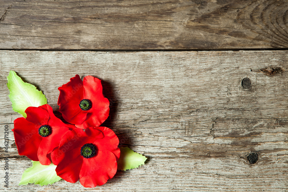 Poppy pin for Remembrance Day. Backed on old beautiful high grain, detailed wood.