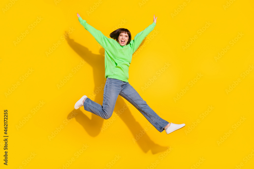 Full length body size view of attractive cheerful girl jumping walking having fun isolated over bright yellow color background