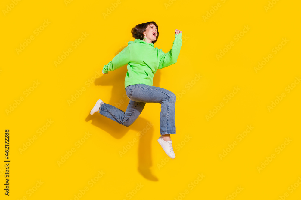 Full body profile side photo of attractive young happy woman jump up run sale isolated on yellow color background