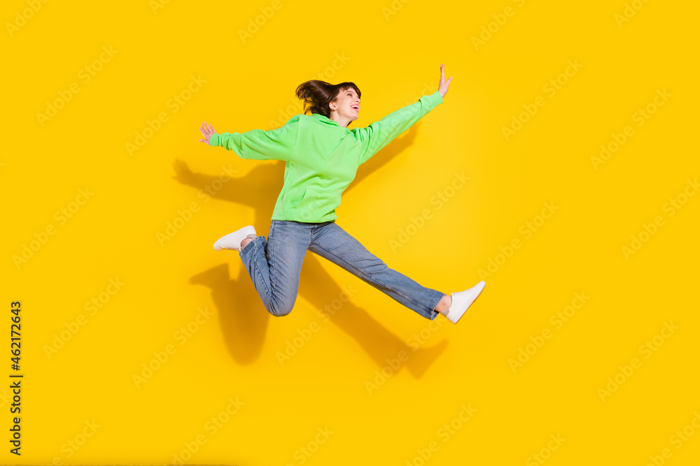 Full body photo of happy young woman good mood raise hands active isolated on yellow color background