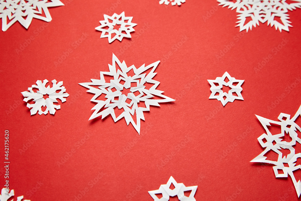 Christmas decoration with white paper snowflakes on red Christmas decoration with white paper snowflakes on red