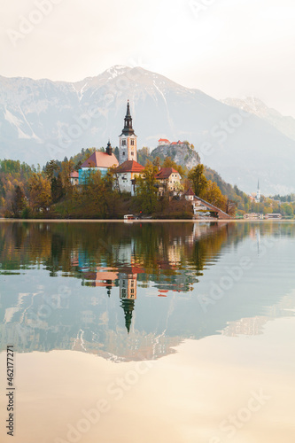 Beautiful cozy Lake Bled and the church on the island in the background with castle in the morning lights in the Julian Alps