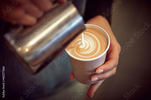 Close up of a woman making cappuccino