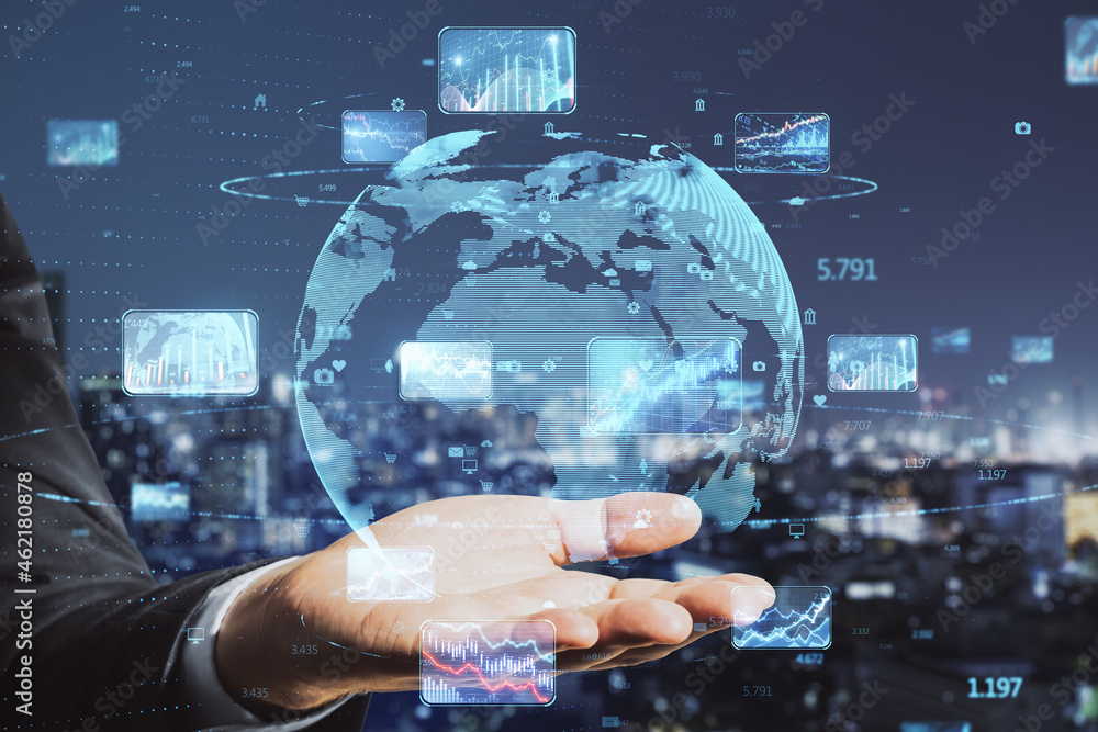 Obraz premium Close up of businessman hand holding abstract globe with forex charts and graphs on blurry night city background. Global trading and market concept. Double exposure.