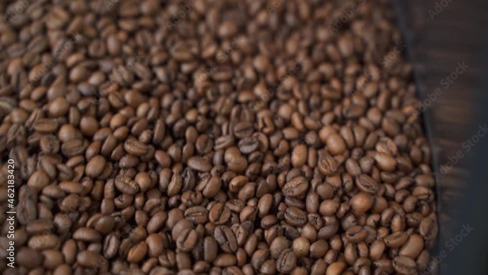 Process of roasting coffee beans with using automatic equipment in modern factory spbas. Closeup of brown arabica or robusta seed rotates inside metal container and undergoes high temperature Process of roasting coffee beans with using automatic equipment in modern factory spbas. Closeup of brown arabica or robusta seed rotates inside metal container and undergoes high temperature