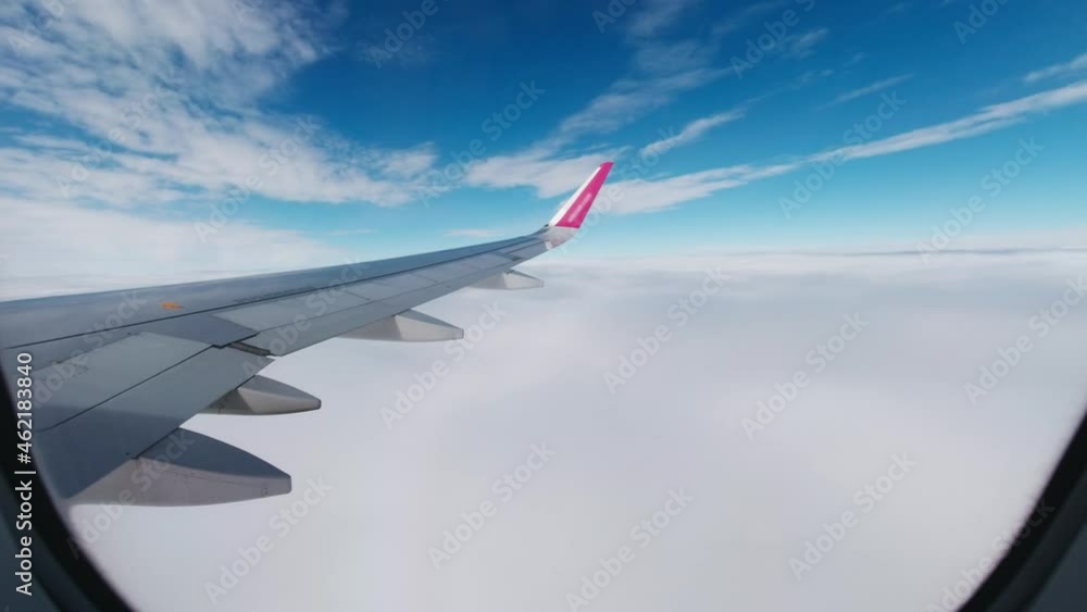 A view from an airplane window during a flight in the clouds. A view from an airplane window during a flight in the clouds.