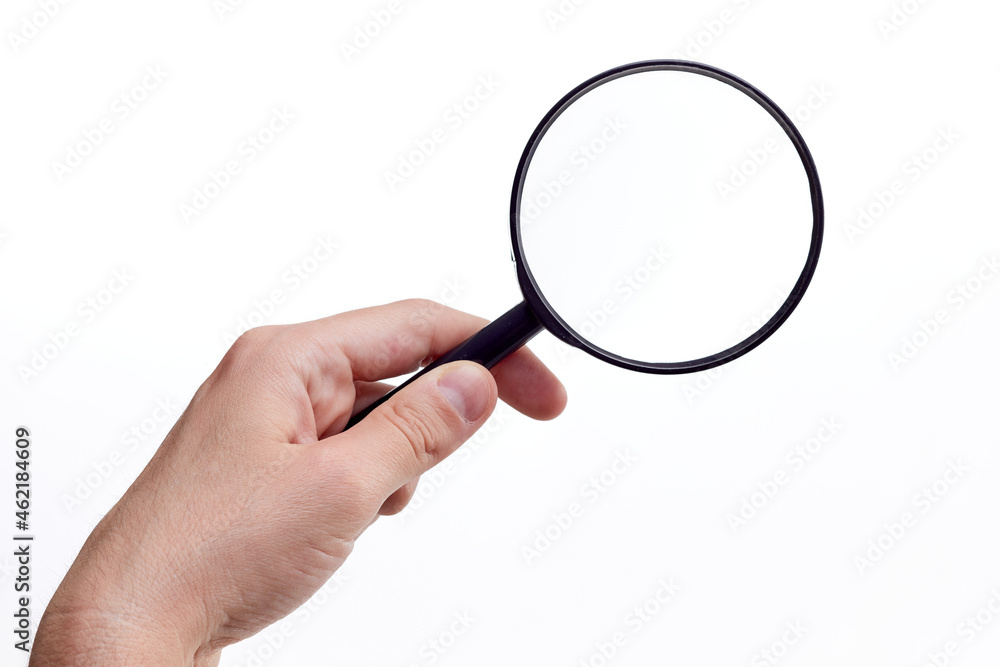 Magnifying glass in hand isolated on white background Magnifying glass in hand isolated on white background