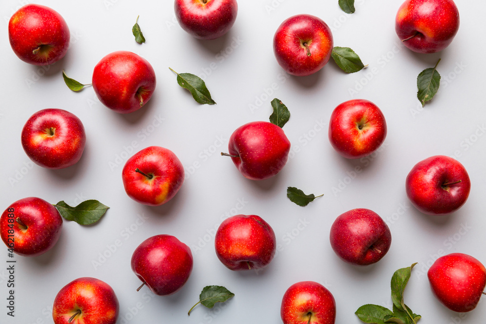 Many red apples on colored background, top view. Autumn pattern with fresh apple above view Many red apples on colored background, top view. Autumn pattern with fresh apple above view