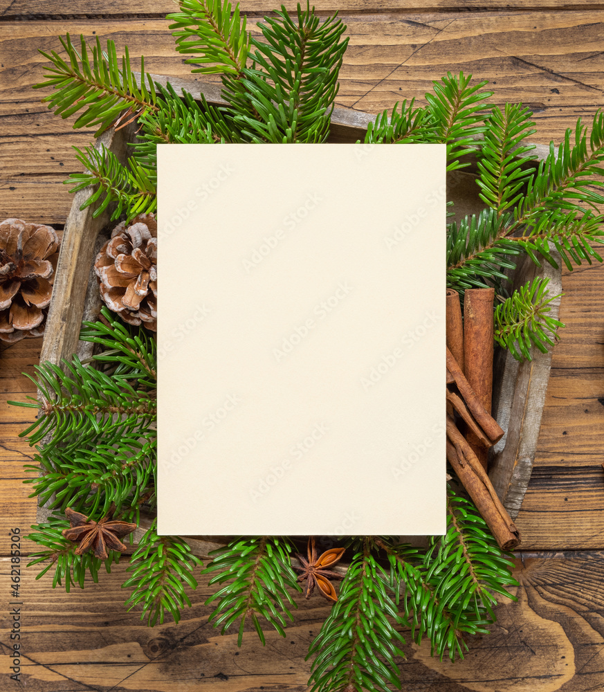 Fototapeta premium Christmas Composition with a blank card and envelope on wooden table