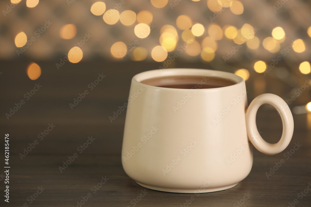 Cup of tasty freshly brewed tea on wooden table, closeup Cup of tasty freshly brewed tea on wooden table, closeup