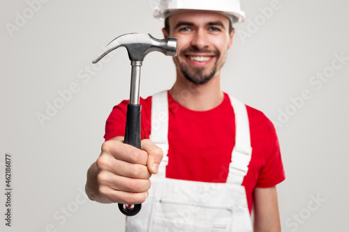 Smiling male builder with hammer