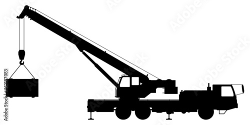 Silhouette of a crane lifting a load.