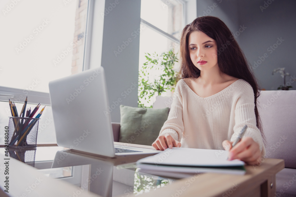 Photo of young business woman sit dest look computer write pen notes to-do list remote work home indoors Photo of young business woman sit dest look computer write pen notes to-do list remote work home indoors