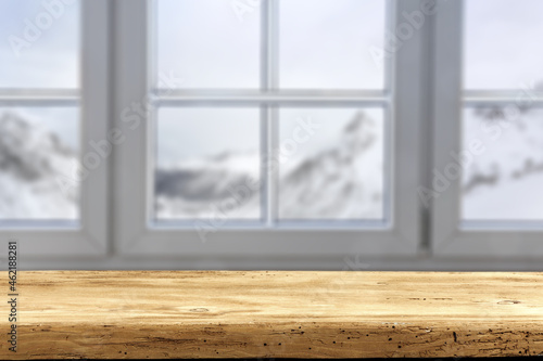 Desk of free space and winter window background. 