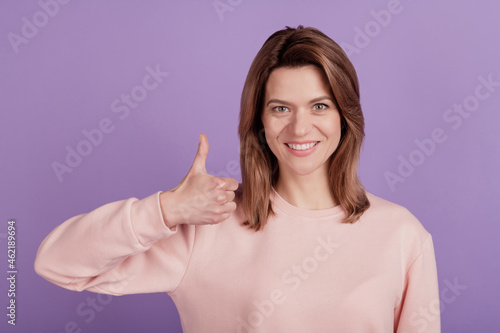 Photo of positive lady show thumb up toothy smile agree tips wear casual shirt on violet background