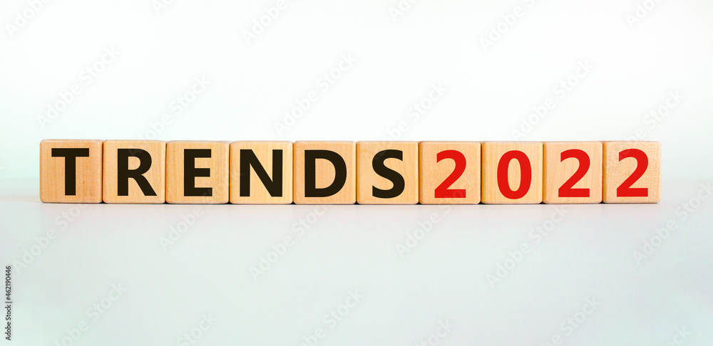 Business concept of 2022 trends symbol. Words 'Trends 2022' on wooden cubes. Beautiful white table, white background. Business and trends 2021 new year concept. Copy space.