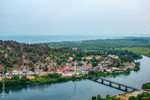 Panorama of the Buna River Valley (Albania). Delightful summer landscape with the Ura e Vjeter e Bunes bridge over the turquoise water stream and the Xhamia e Ures se Bunes mosque on the shore photo