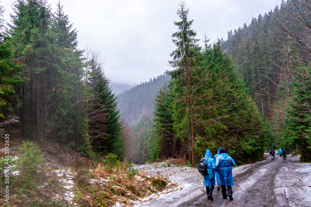 People on raincoats on ice road, the Carpathian Mountains, Ukraine