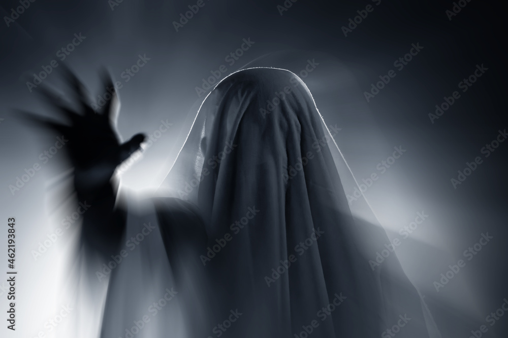Halloween concept with ghost in smoky night Halloween concept with ghost in smoky night