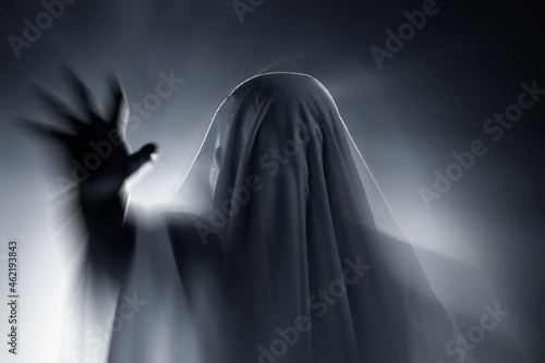 Halloween concept with ghost in smoky night