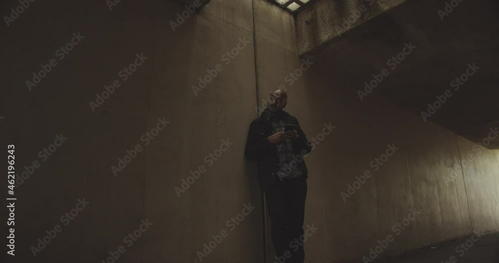 Man Waiting For Friend In Tunnel. Wide Shot, Tilt up, Locked. Man Waiting For Friend In Tunnel. Wide Shot, Tilt up, Locked.