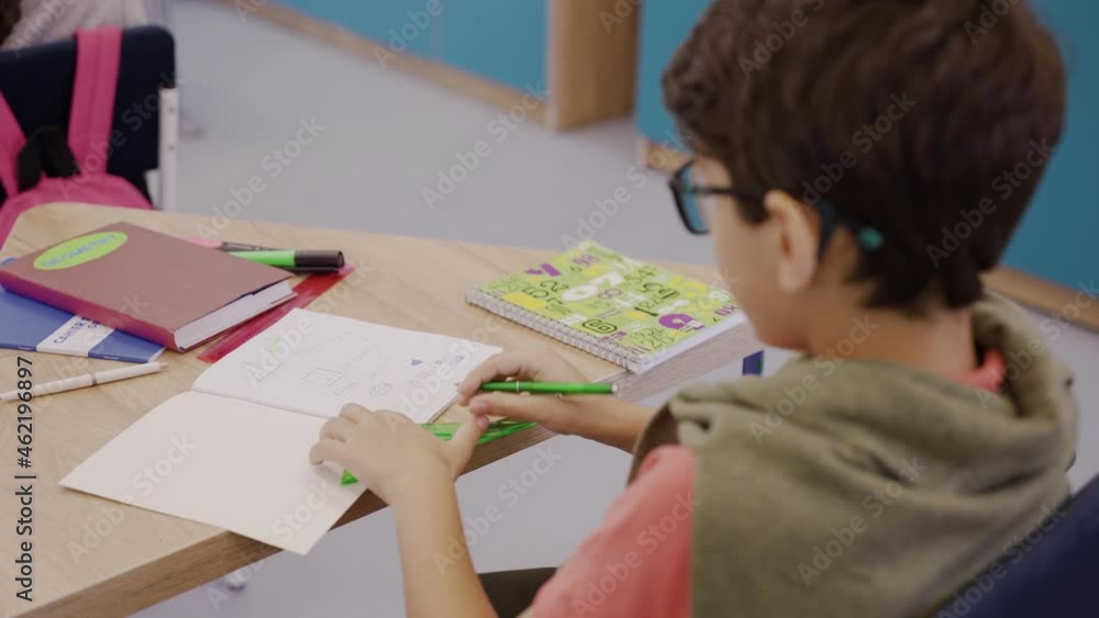 Careful boy drawing in geometry lesson with ruler and pencil. Clever young boy studying geometry in elementary school.High quality 4k footage Careful boy drawing in geometry lesson with ruler and pencil. Clever young boy studying geometry in elementary school.High quality 4k footage